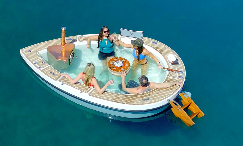 Spacruzzi Is a Floating Hot Tub Boat With a Built-in Fireplace and Cooler