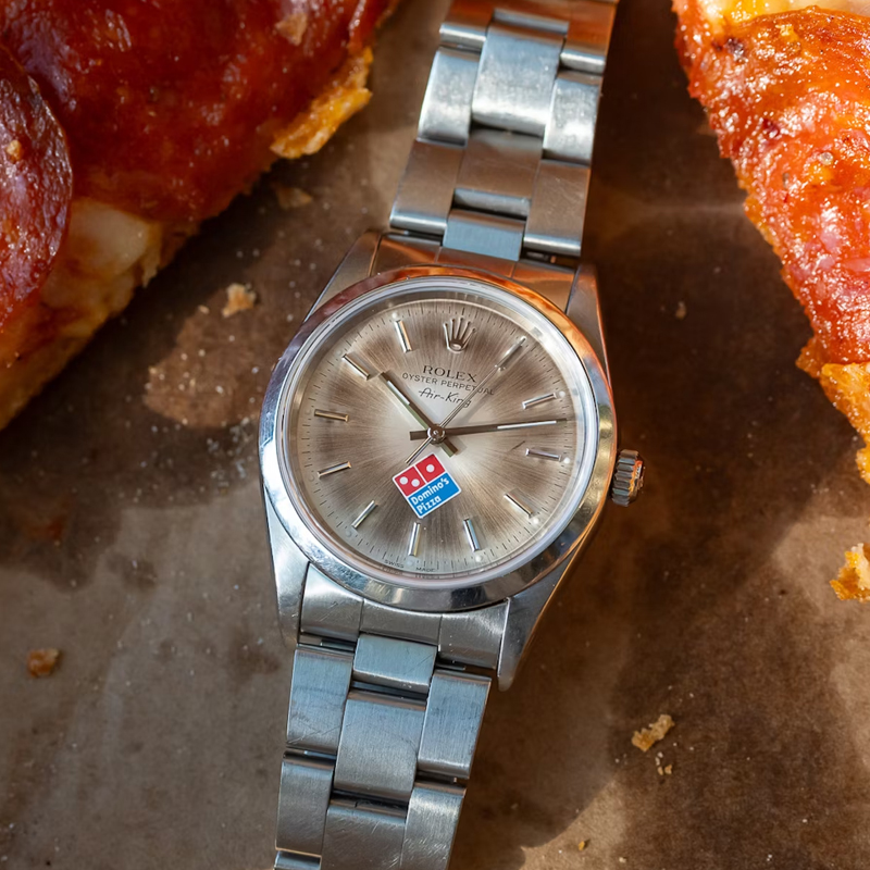 The Domino's Rolex Air-King With A Slice Of Pizza